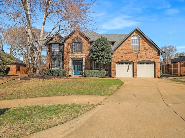 view of front of property with a front lawn and a garage