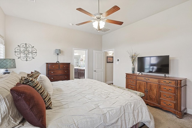 bedroom featuring light carpet, baseboards, visible vents, a ceiling fan, and ensuite bathroom