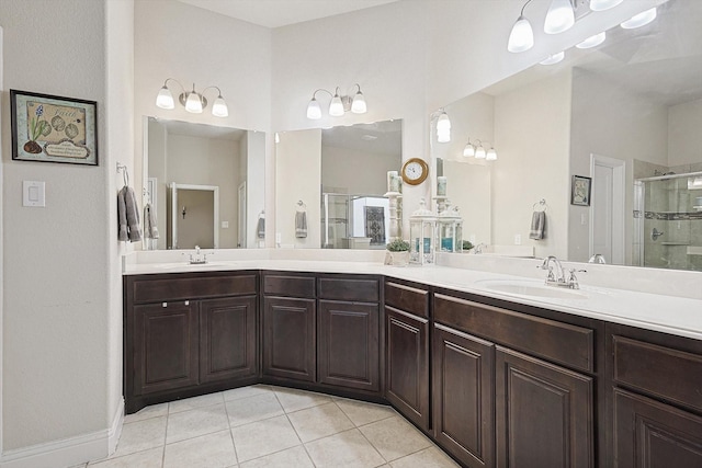 bathroom featuring a stall shower, tile patterned flooring, a sink, and double vanity