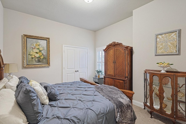 bedroom with carpet and a textured ceiling