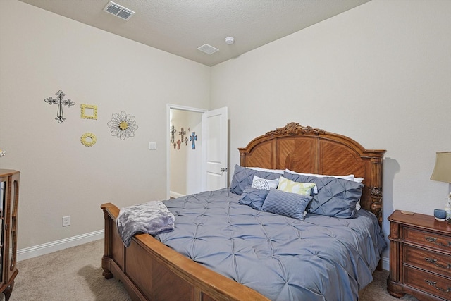 bedroom with baseboards, visible vents, a textured ceiling, and light colored carpet