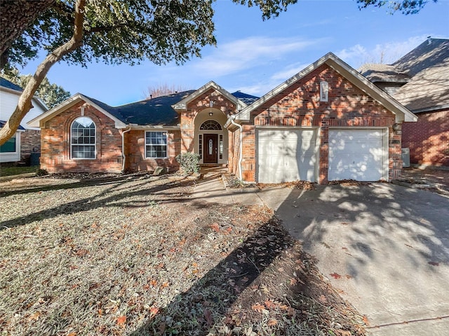 ranch-style house featuring a garage, aphalt driveway, and brick siding