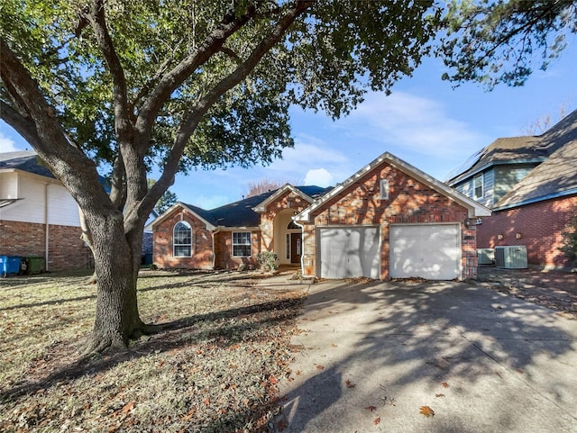 ranch-style house featuring central AC unit, an attached garage, brick siding, driveway, and a front lawn