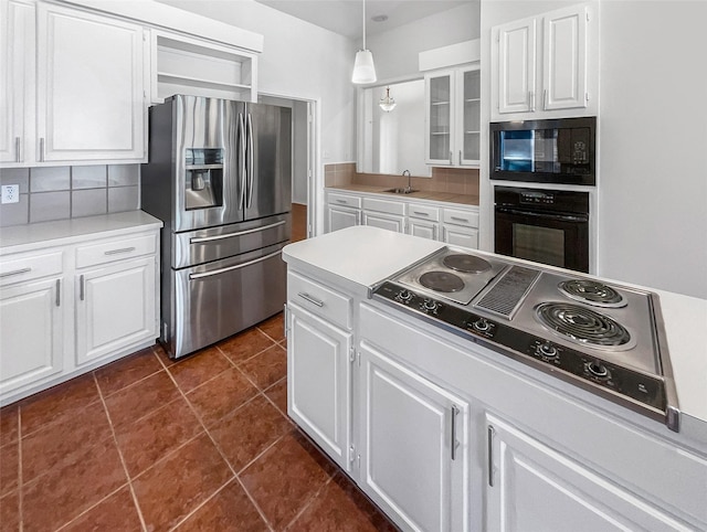 kitchen with white cabinets, glass insert cabinets, hanging light fixtures, light countertops, and black appliances