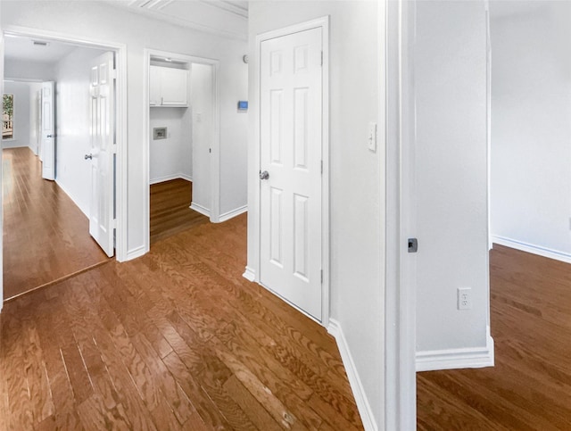 hall featuring baseboards and wood finished floors