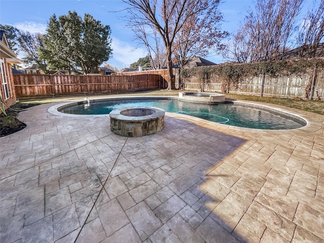 view of pool with a fire pit, a patio, a fenced backyard, and a pool with connected hot tub