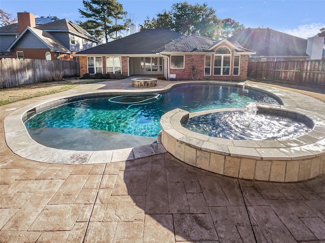 view of pool with an outdoor fire pit, a patio area, a fenced backyard, and a pool with connected hot tub