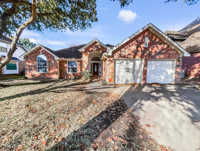 ranch-style house with aphalt driveway, brick siding, and an attached garage