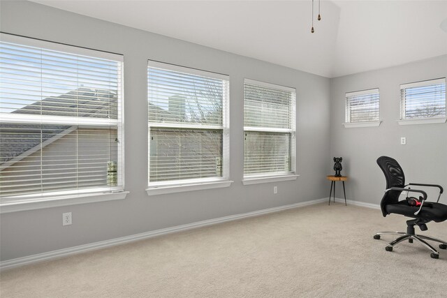 unfurnished bedroom with lofted ceiling, ceiling fan, light carpet, and baseboards