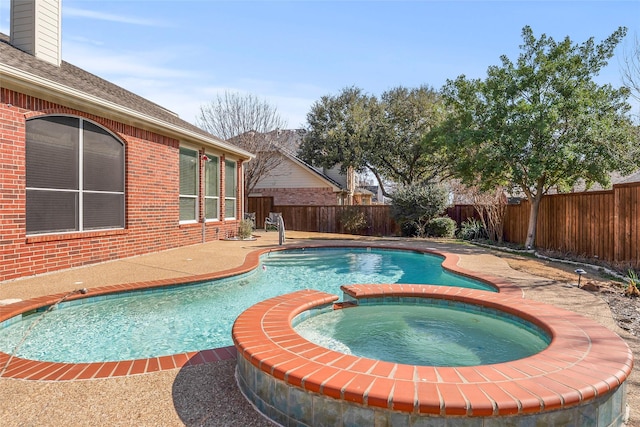 view of pool with a pool with connected hot tub and a fenced backyard