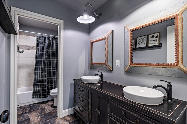 full bathroom with shower / tub combo, vanity, and toilet