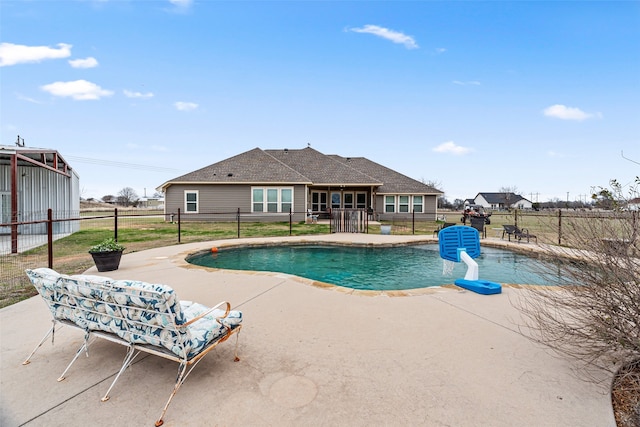 view of swimming pool featuring a patio and a yard