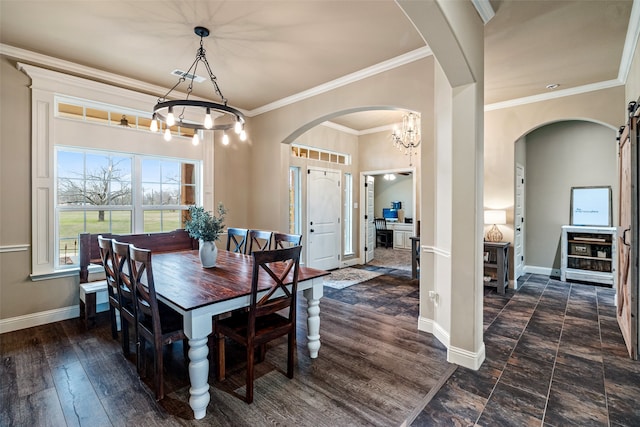 dining area with ornamental molding, a chandelier, and dark hardwood / wood-style floors