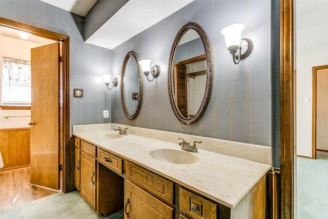 bathroom with a textured ceiling and vanity