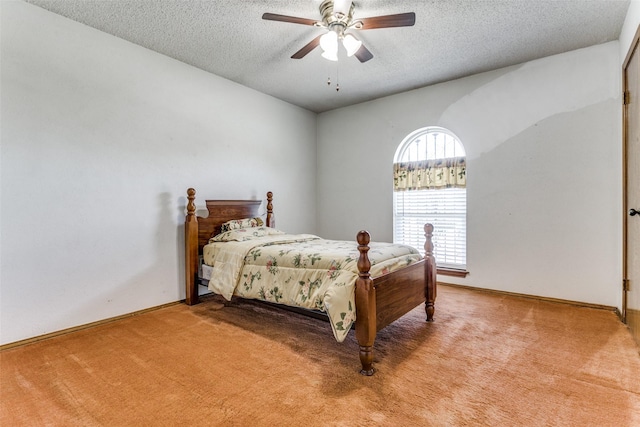 carpeted bedroom with a textured ceiling and ceiling fan