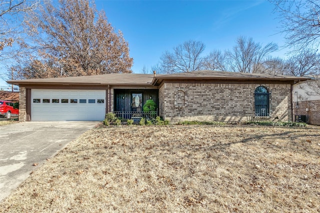 single story home featuring central AC and a garage