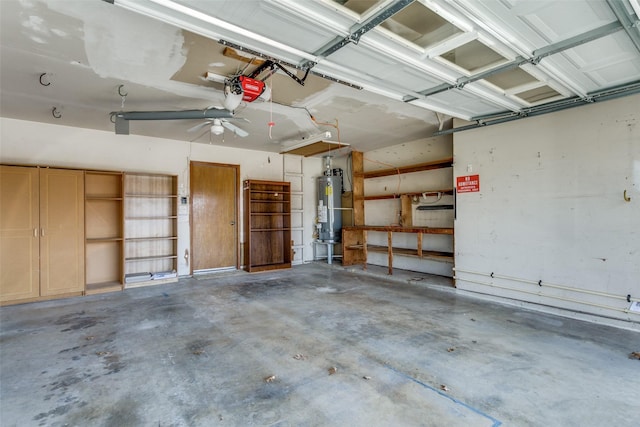 garage featuring gas water heater and a garage door opener