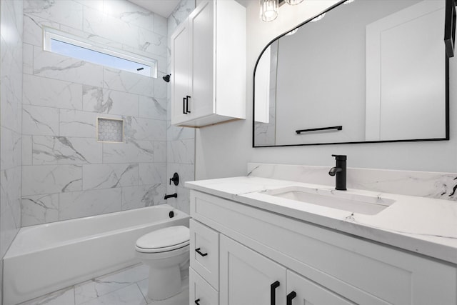 full bathroom with toilet, vanity, and tiled shower / bath