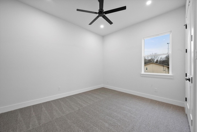 carpeted spare room with ceiling fan