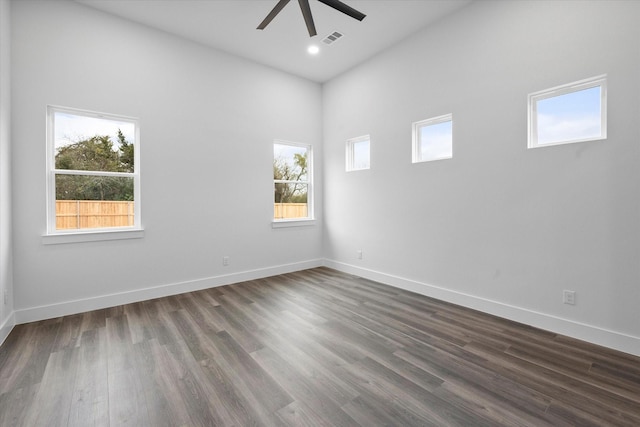 unfurnished room featuring dark wood-type flooring and ceiling fan