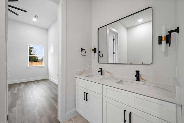 bathroom featuring vanity, hardwood / wood-style floors, and ceiling fan