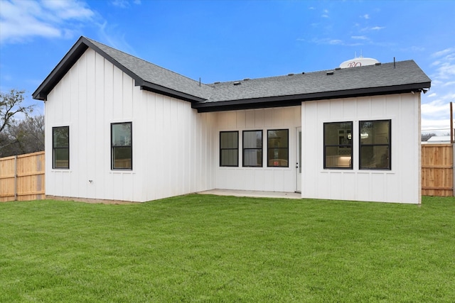 rear view of property with a yard and a patio area