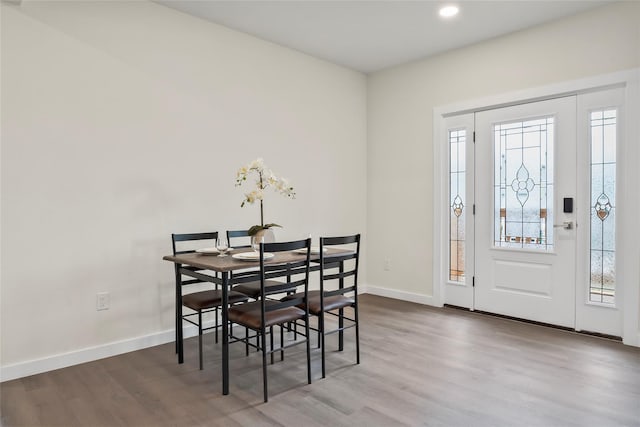 dining space with hardwood / wood-style flooring