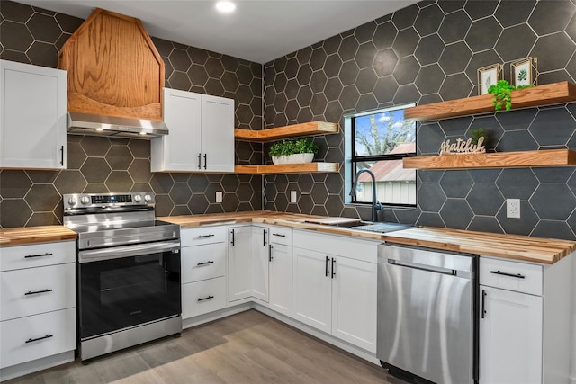 kitchen featuring white cabinetry, backsplash, and stainless steel appliances