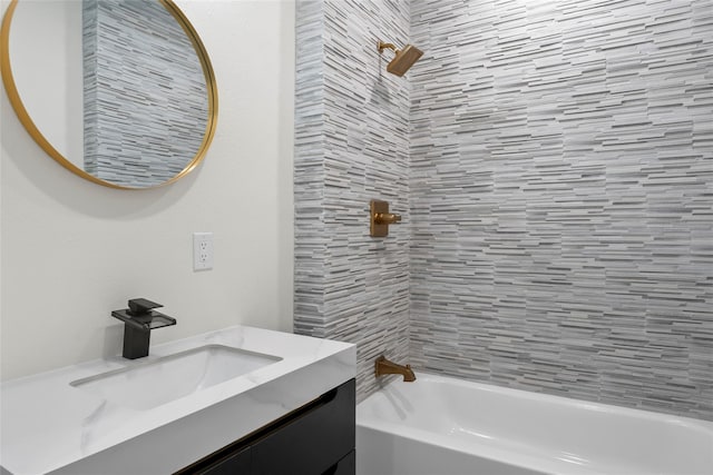 bathroom with vanity and tiled shower / bath