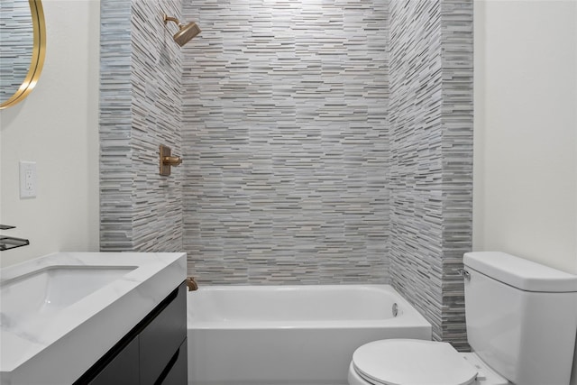 full bathroom featuring vanity, toilet, and tiled shower / bath