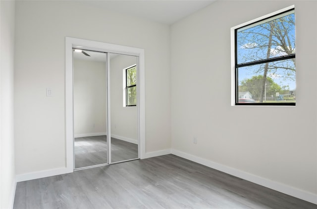 unfurnished bedroom featuring hardwood / wood-style flooring and a closet