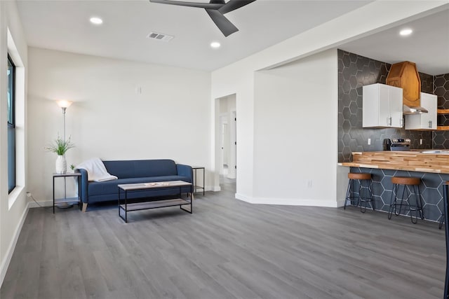 sitting room with ceiling fan and light hardwood / wood-style flooring