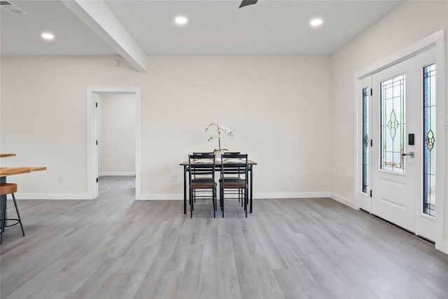 entryway featuring light hardwood / wood-style floors and beam ceiling