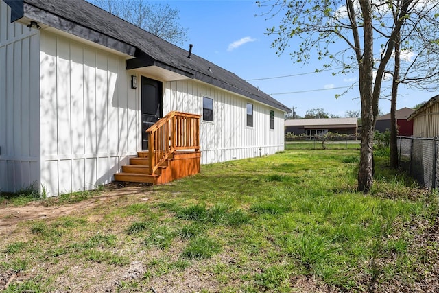 back of property featuring a lawn