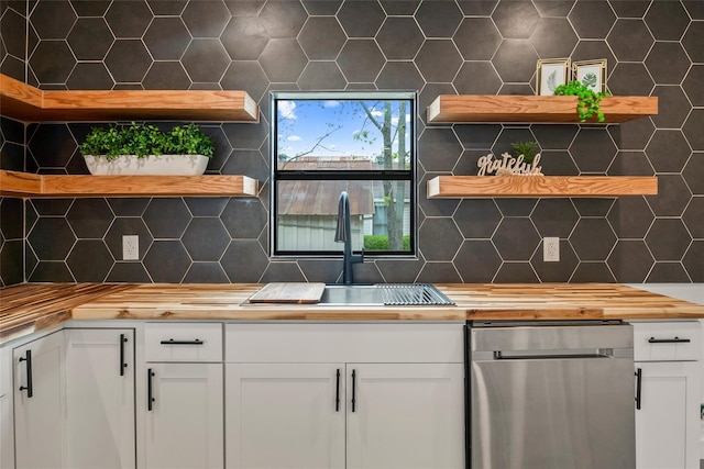 kitchen with sink, white cabinets, and tasteful backsplash