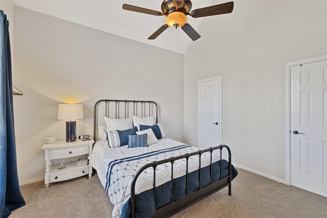 carpeted bedroom with lofted ceiling, a ceiling fan, and baseboards