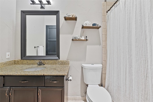 bathroom featuring toilet and vanity