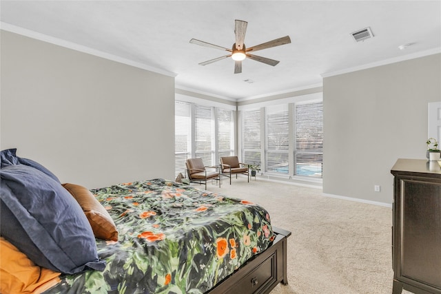 bedroom featuring ceiling fan, light colored carpet, visible vents, baseboards, and crown molding