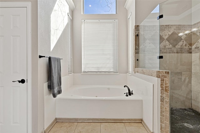 bathroom featuring a stall shower, tile patterned flooring, and a bath