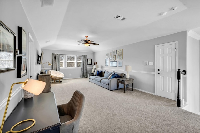 carpeted living area with baseboards, visible vents, and a ceiling fan