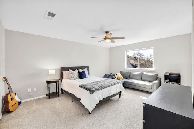 bedroom featuring baseboards, ceiling fan, visible vents, and light colored carpet