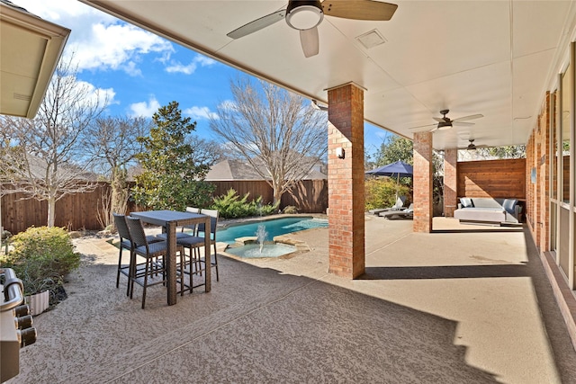 view of patio with a fenced in pool, outdoor dining space, a fenced backyard, and a ceiling fan