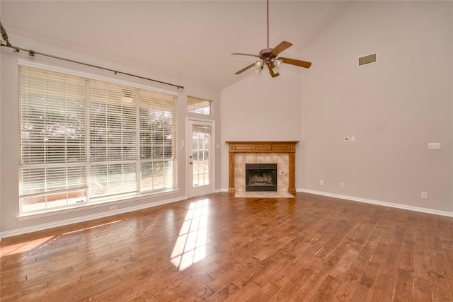 unfurnished living room featuring ceiling fan, high vaulted ceiling, wood-type flooring, and a fireplace