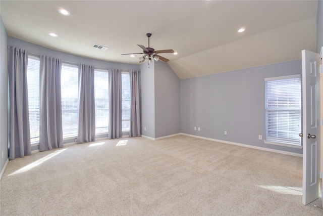 carpeted spare room featuring lofted ceiling and ceiling fan