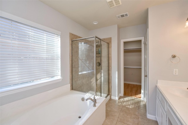 bathroom with plus walk in shower, vanity, and tile patterned floors