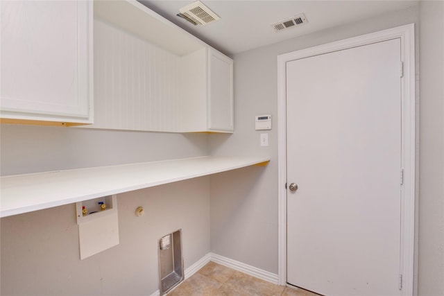 laundry area featuring hookup for a washing machine and cabinets