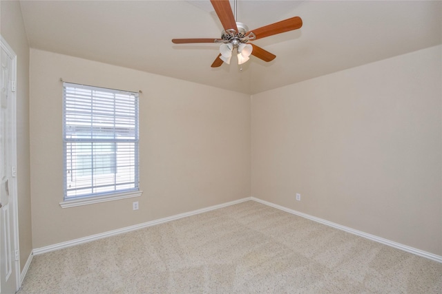 spare room with ceiling fan and light colored carpet