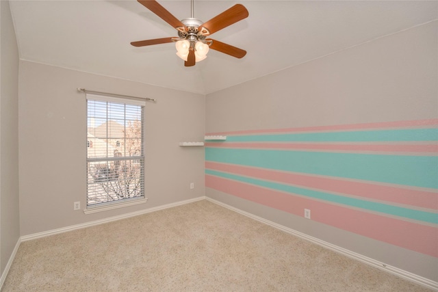 carpeted spare room featuring ceiling fan and lofted ceiling