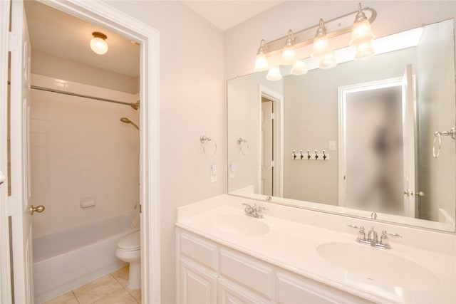 full bathroom with tiled shower / bath combo, tile patterned flooring, vanity, and toilet