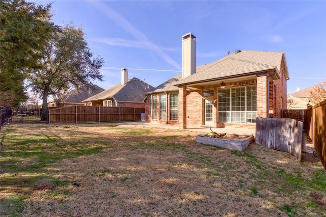 back of house featuring a yard